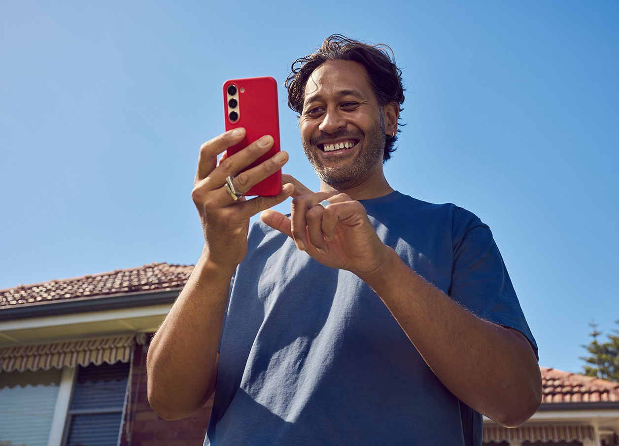 Man on phone outside of house