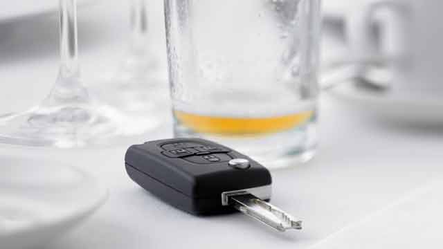 Car key beside empty drink