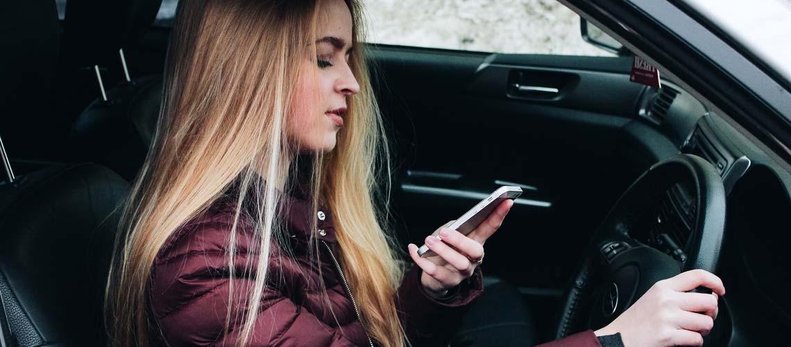 Woman driving using mobile phone