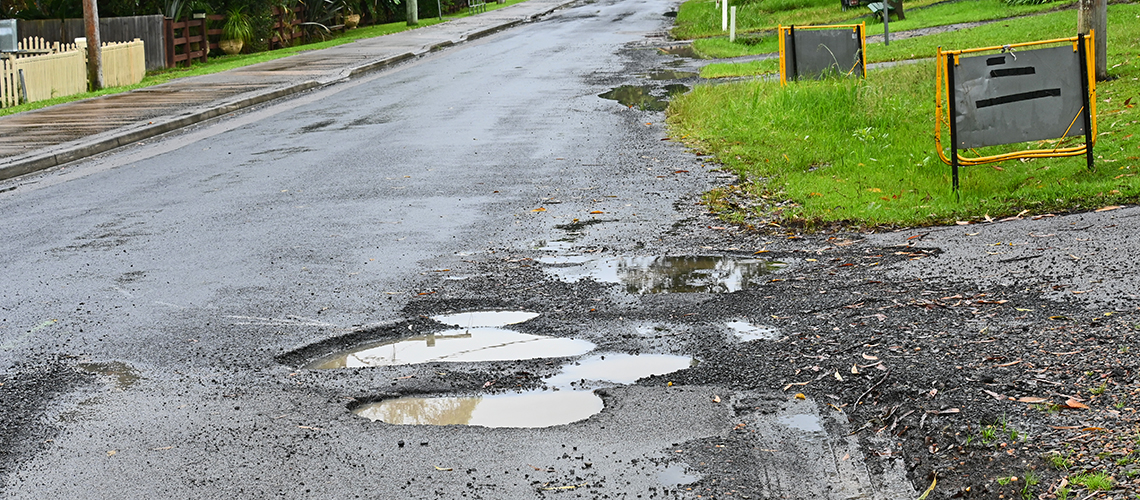 potholes on road after rain