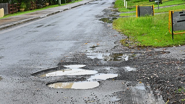 Potholes on road after rain
