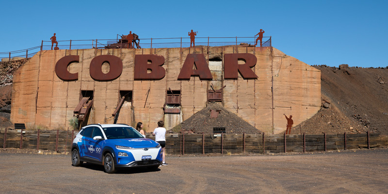 blue nrma vehicle parked in front of cobar sign
