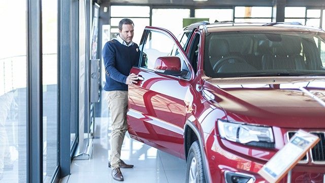Man in a car showroom looking to buy a business vehicle
