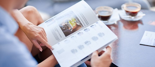 Couple pointing at car brochure