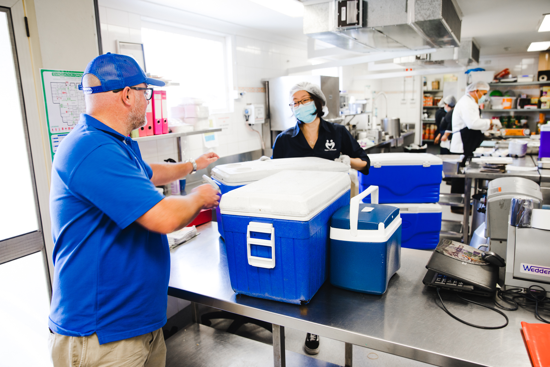 NRMA staff volunteer picking up food for delivery from Meals on Wheels