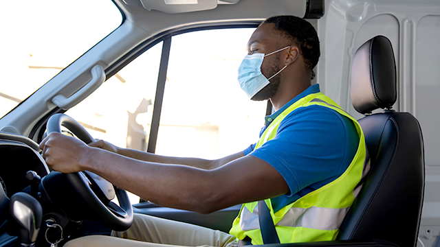 Man driving van with mask