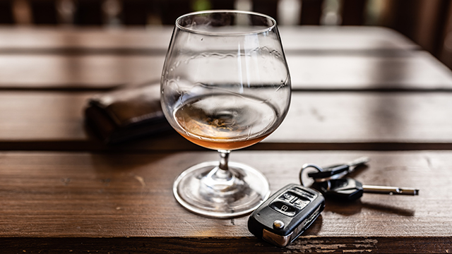 Drinking glass next to car keys
