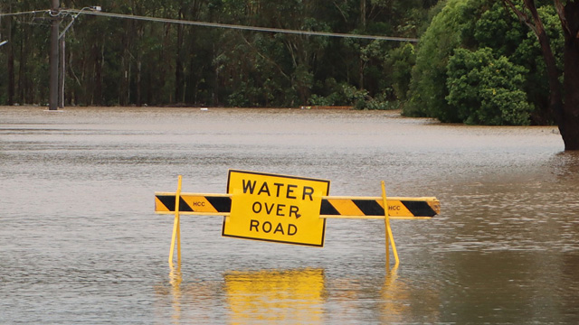 flooded road with warning sign