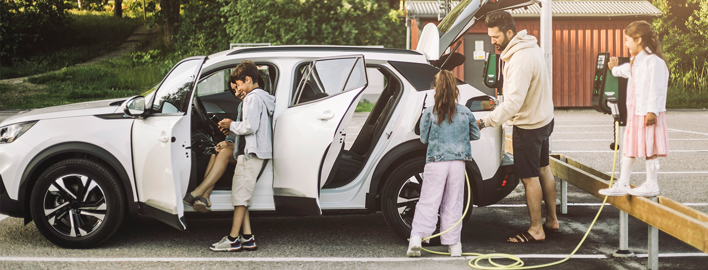 Family at an electric vehicle charging station