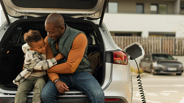 Father and son in an electric vehicle