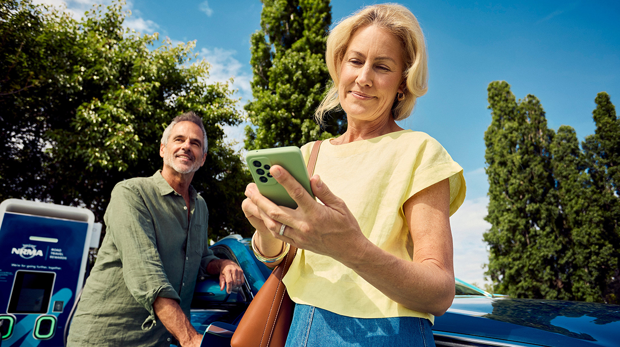 man and woman at ev charging station
