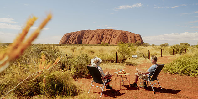 Road trippers stop over and enjoy Uluru view