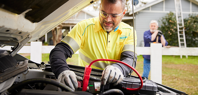 NRMA service provider installing a car battery