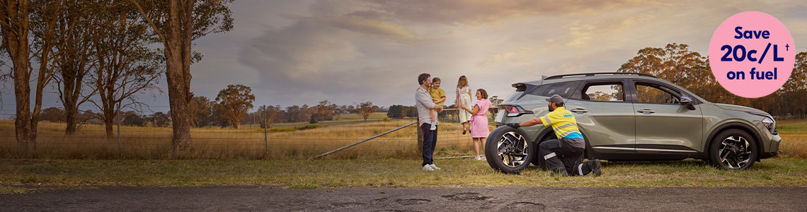 NRMA RSA staff member helping family replace vehicle tyre on the side of the road