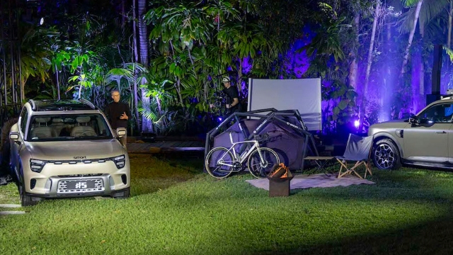 Two 2024 Smart #5 EVs parked on grassy, camp site terrain in a night setting.