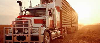 Heavy commercial vehicle driving sunset