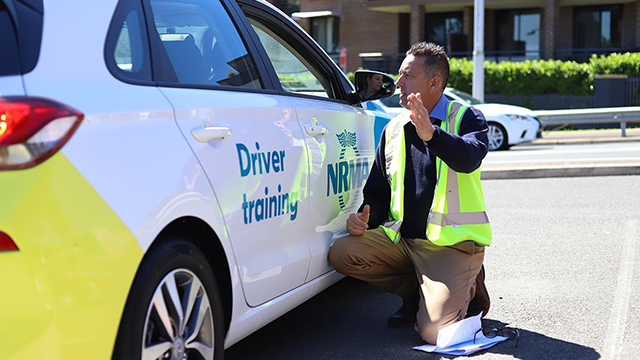 NRMA Driver Training expert beside car