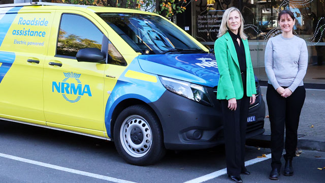 Two women standing beside an NRMA EV patrol van