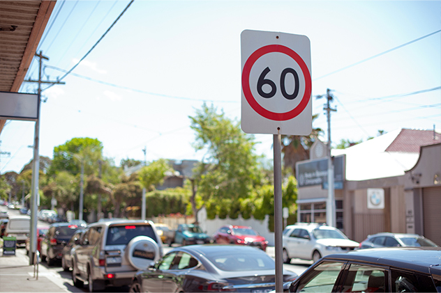 60 speed limit sign on an urban street