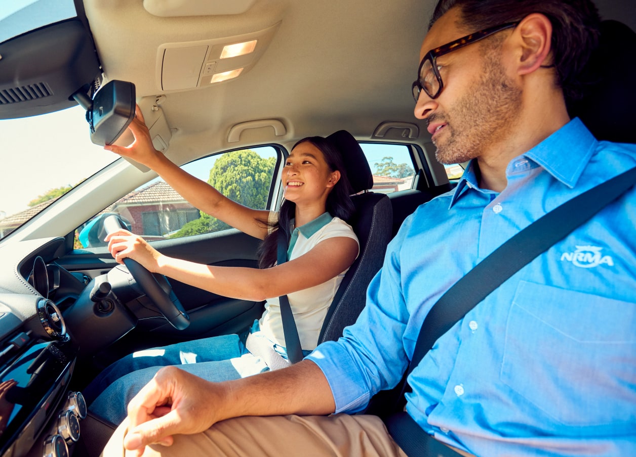 An NRMA Driving Instructor inside a car with a student
