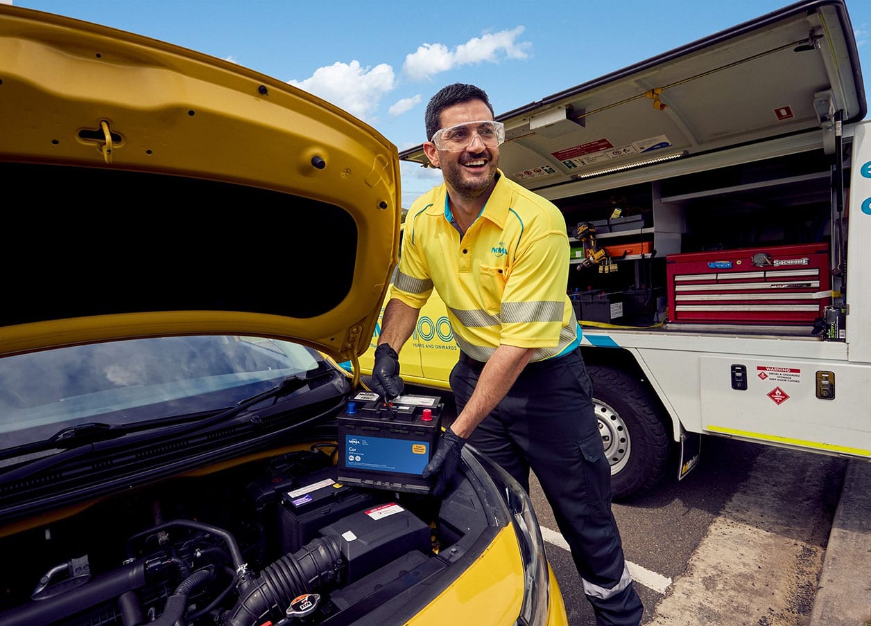An NRMA technician changing out a car battery