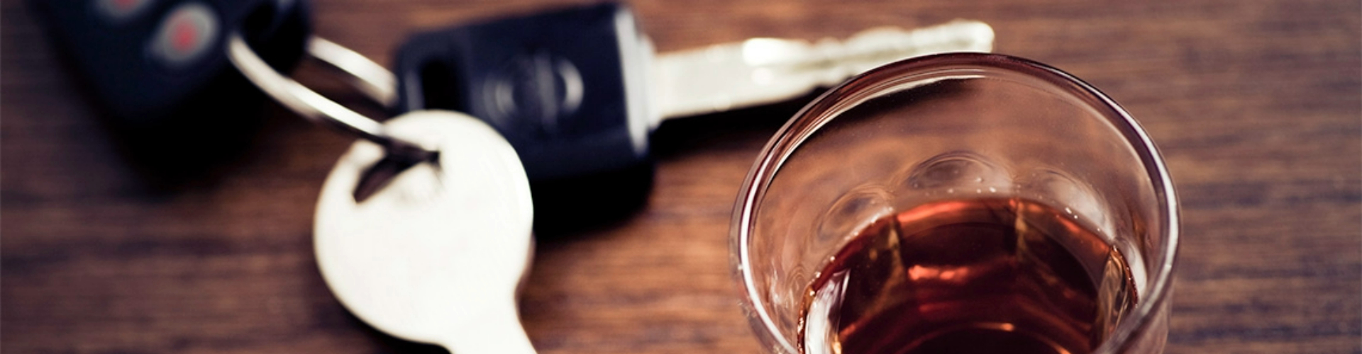 keys-and-alcoholic-drink-1920x800 Close up of keys and a half-finished alcoholic drink.