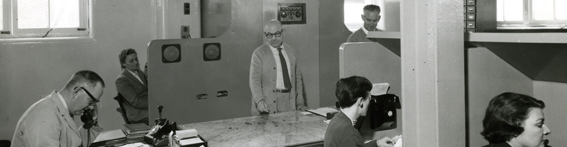 NRMA Call Centre 1970s 1 black and white picture of six employees using old-fashioned phones and a map to manage assistance calls and nrma patrol deployments