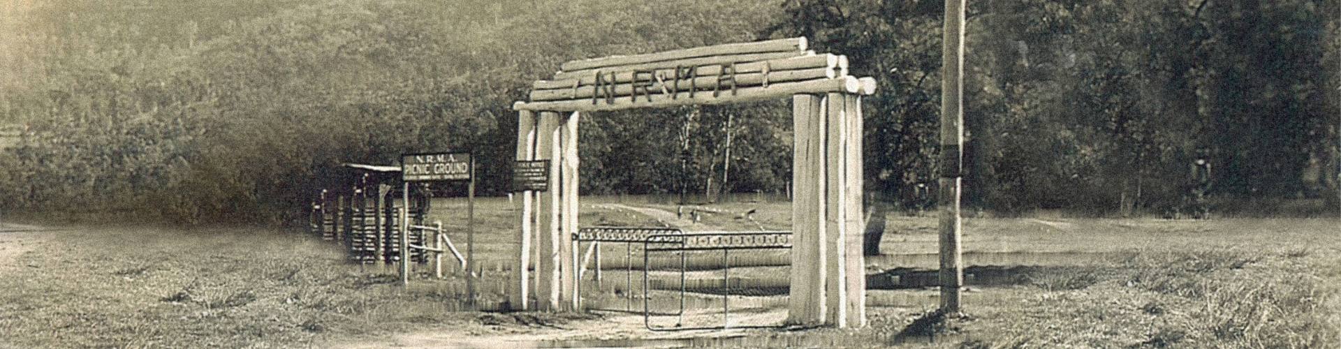 NRMA Motor Parks 1930s bw park entrance 1930s black and white picture of the gate and wooden archway entrance to an NRMA motor park picnic and camping ground