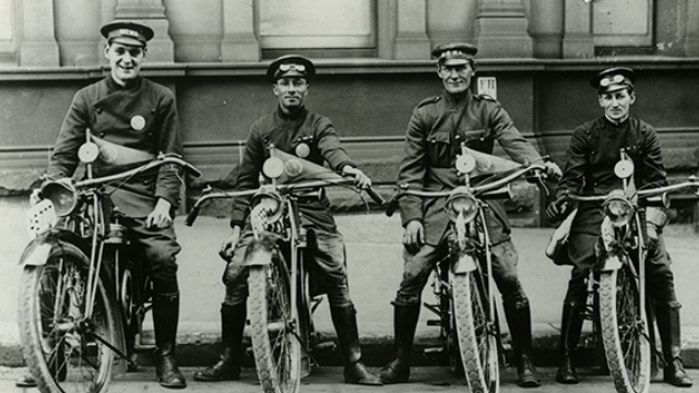 historic black and white image of four nrma road patrol employees on vintage motorcycles