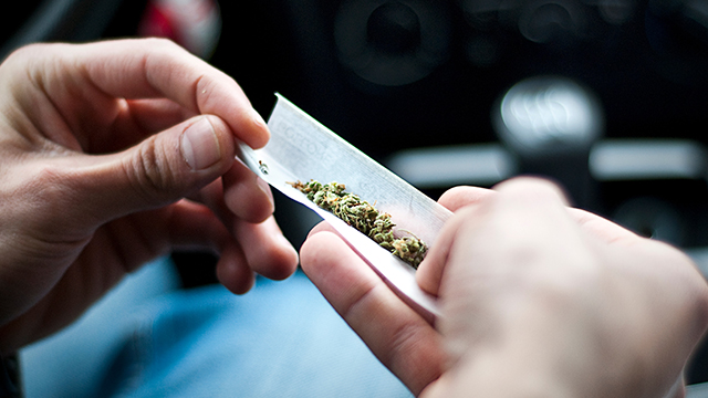 man making joint in the car