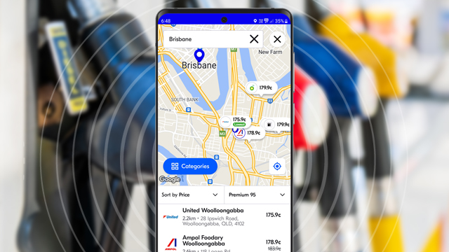 image of mobile phone with fuel app open in foreground for Brisbane area with blurred image of fuel bowser in the background