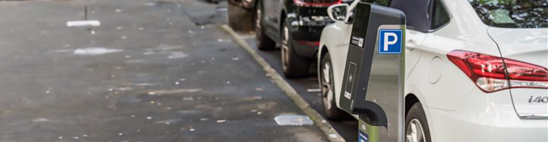 Parking meter in front of a white car