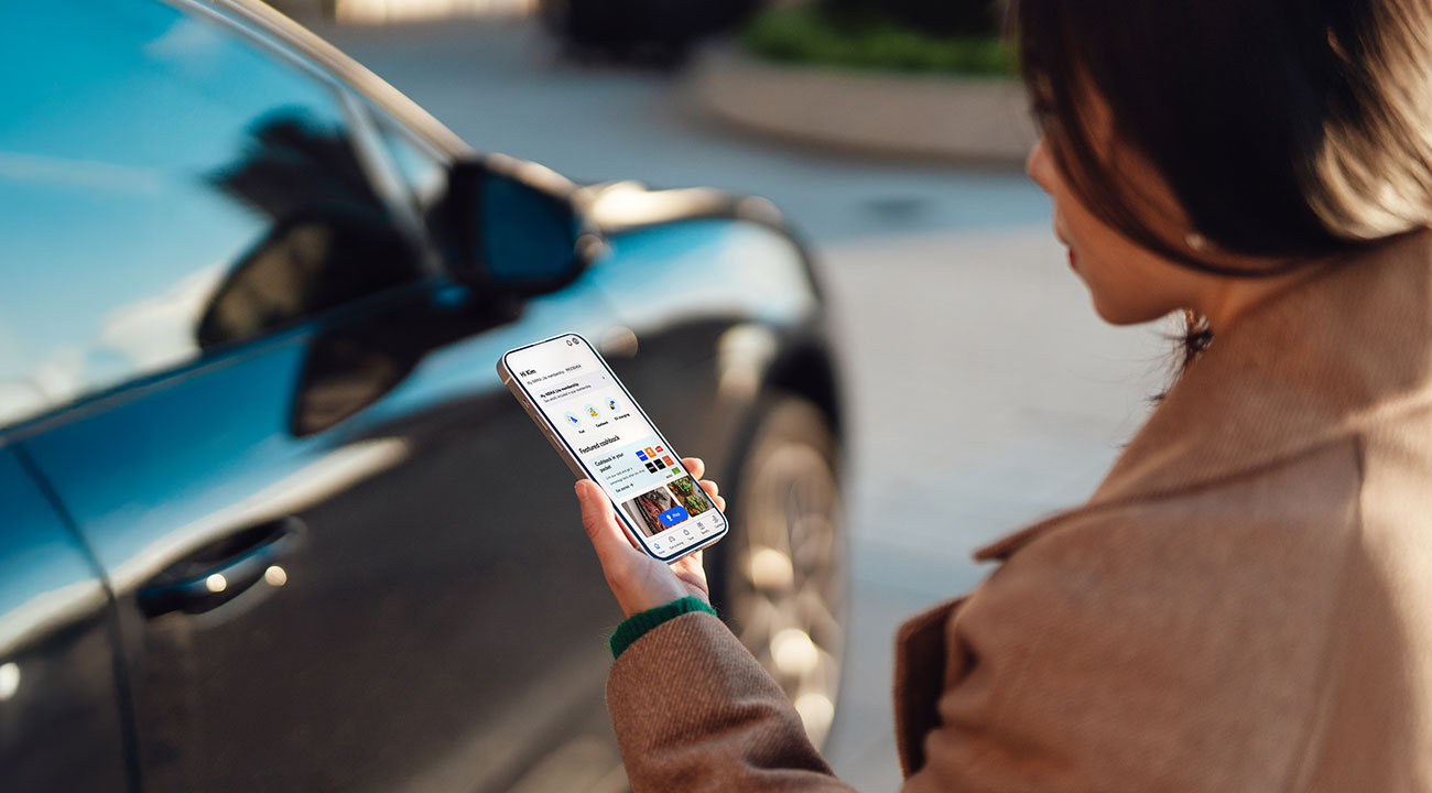 lady looking at her phone which is logged into the My NRMA app