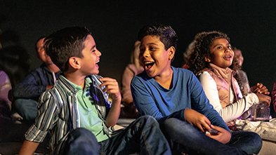 Kids watching movies under the stars