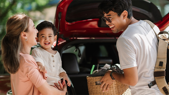 Asian family at the boot of a car