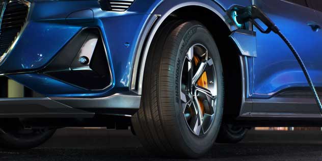 A close up of a hancook tyre on a blue EV