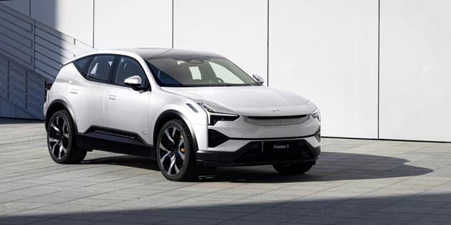A white Polestar 3 parked in front of a white panel wall