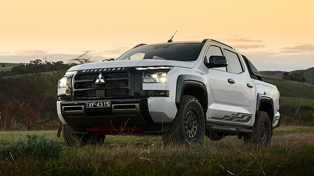 Mitsubishi Triton Raider on grass at sunset