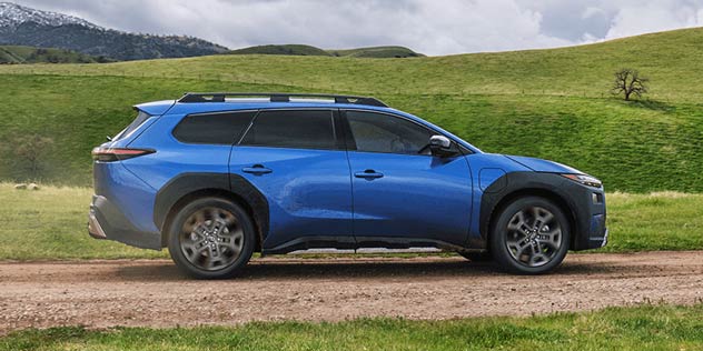 Blue SUV on grassy track