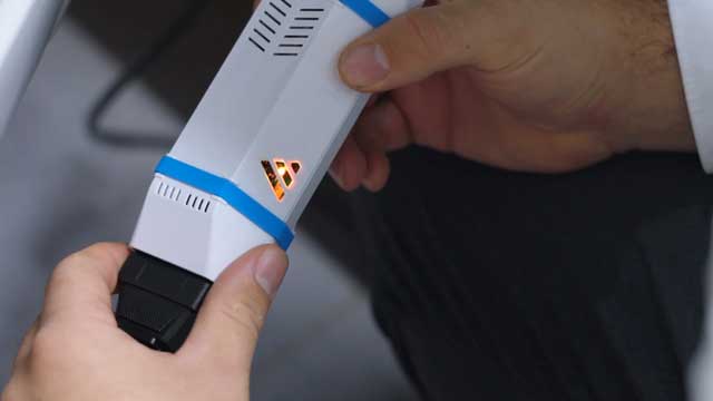 A hand holding an EV battery check device