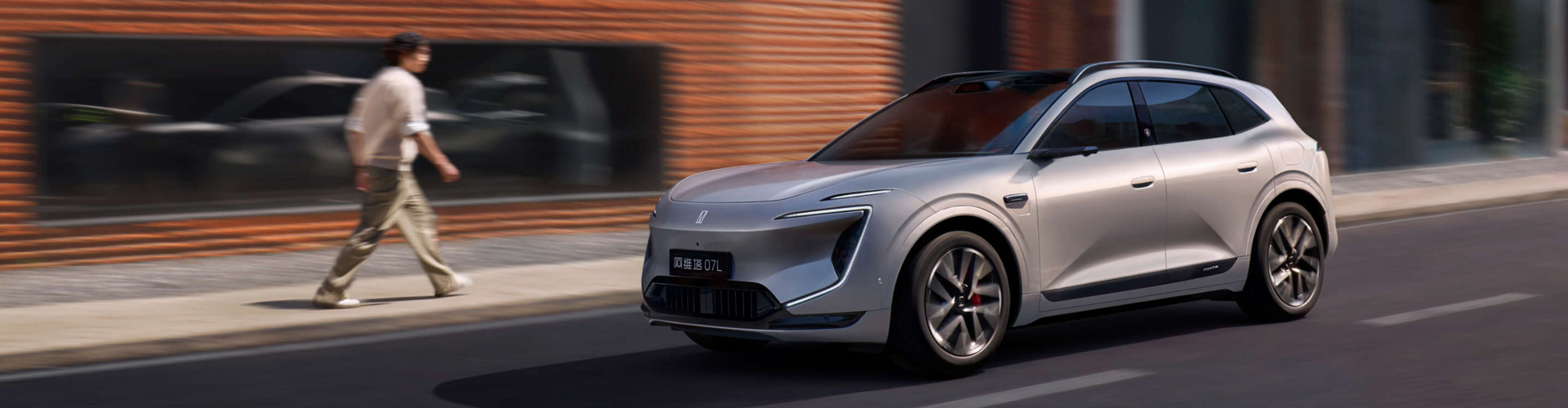 An Avatr electric car with person walking alongside