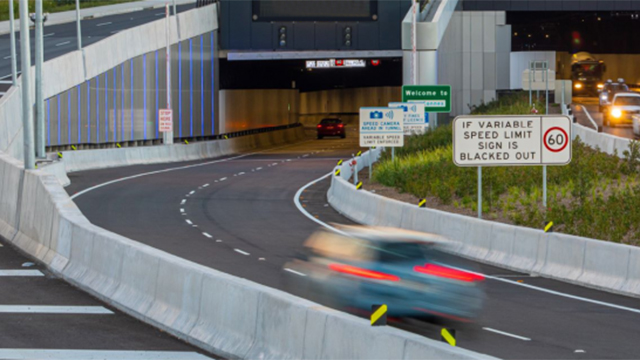 A car driving towards a motorway tunnel
