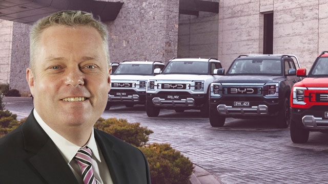 Stephen Collins in from of a lineup of BYD Shark 6s