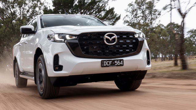 A white Mazda BT-50 on a dirt road