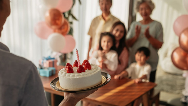 A family waiting for a cake