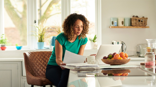 Woman paying bills on her laptop