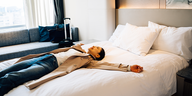 A woman in a hotel room lying on the bed