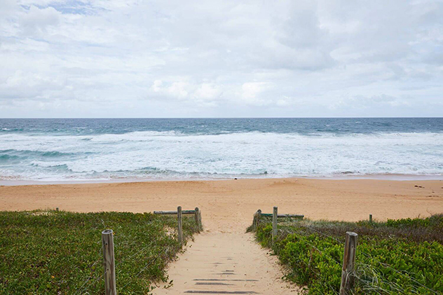 A pathway leading down to a surf beach