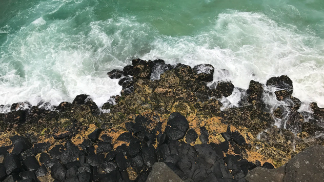 Looking down at Fingal basalt columns and waves