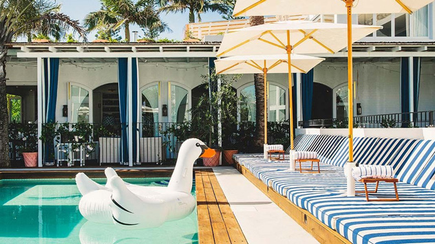 A white blow up flamingo in a pool